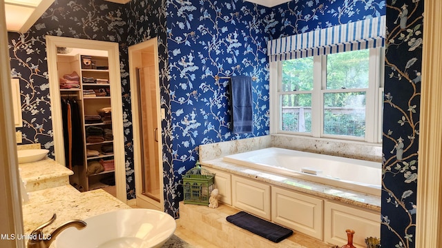 bathroom featuring a tub to relax in and sink