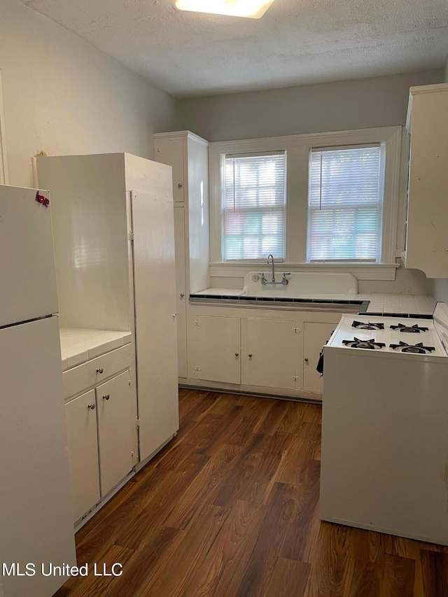 409 E Mayes St Unit 1, 2, 3, Jackson, MS 39206 - kitchen featuring white appliances, white cabinetry, dark wood-style floors, and a textured ceiling