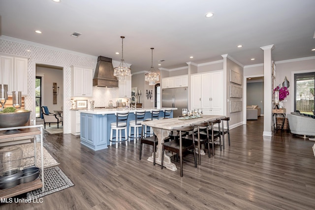 2011 Ivy Ct, Biloxi, MS 39532 - dining space featuring a healthy amount of sunlight, ornamental molding, dark wood finished floors, and visible vents