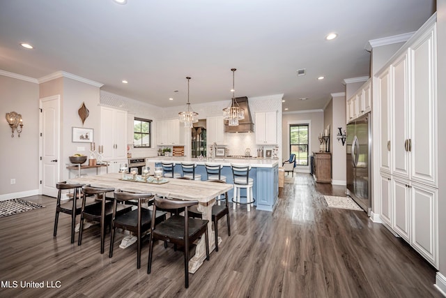 2011 Ivy Ct, Biloxi, MS 39532 - dining room featuring ornamental molding, baseboards, dark wood-style floors, and a healthy amount of sunlight