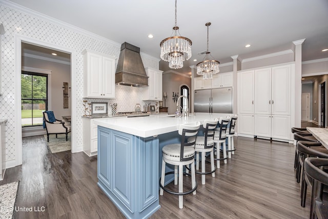 2011 Ivy Ct, Biloxi, MS 39532 - kitchen with a sink, stainless steel appliances, custom exhaust hood, white cabinetry, and a notable chandelier