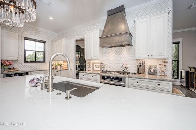 2011 Ivy Ct, Biloxi, MS 39532 - kitchen featuring ornamental molding, light stone counters, a sink, custom range hood, and appliances with stainless steel finishes