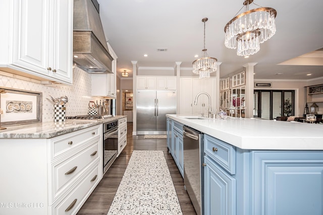 2011 Ivy Ct, Biloxi, MS 39532 - kitchen with an inviting chandelier, a sink, custom exhaust hood, appliances with stainless steel finishes, and blue cabinetry