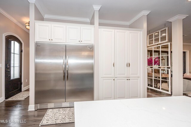 2011 Ivy Ct, Biloxi, MS 39532 - kitchen featuring white cabinetry, ornamental molding, and built in refrigerator