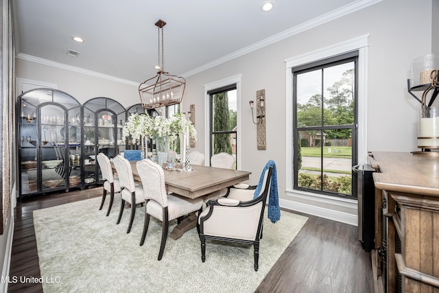 2011 Ivy Ct, Biloxi, MS 39532 - dining space with crown molding, an inviting chandelier, visible vents, and dark wood finished floors