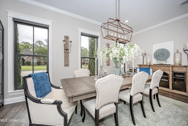 2011 Ivy Ct, Biloxi, MS 39532 - dining area featuring an inviting chandelier, wood finished floors, crown molding, visible vents, and baseboards