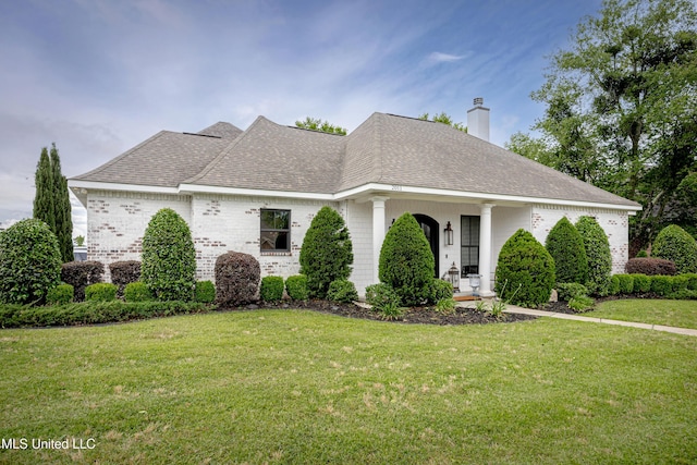 2011 Ivy Ct, Biloxi, MS 39532 - view of front of property featuring a front lawn, a shingled roof, brick siding, and a chimney