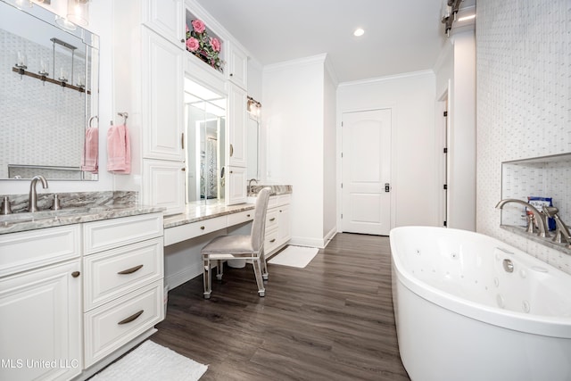 2011 Ivy Ct, Biloxi, MS 39532 - full bath with wood finished floors, a whirlpool tub, crown molding, vanity, and recessed lighting