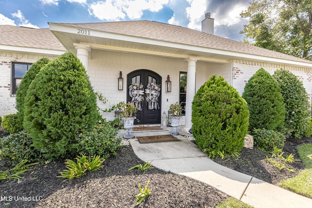 2011 Ivy Ct, Biloxi, MS 39532 - property entrance featuring a chimney, a porch, brick siding, and a shingled roof
