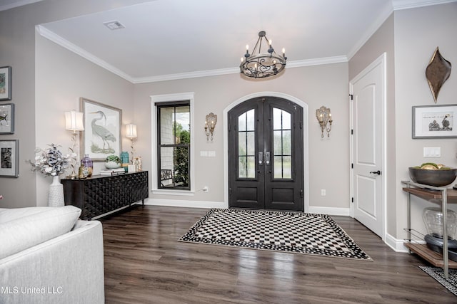 2011 Ivy Ct, Biloxi, MS 39532 - foyer with ornamental molding, an inviting chandelier, dark wood finished floors, and arched walkways