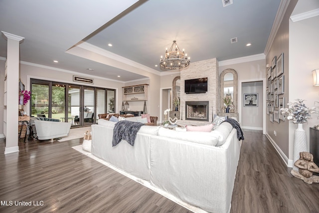 2011 Ivy Ct, Biloxi, MS 39532 - living room with baseboards, a fireplace, dark wood-style flooring, crown molding, and a notable chandelier