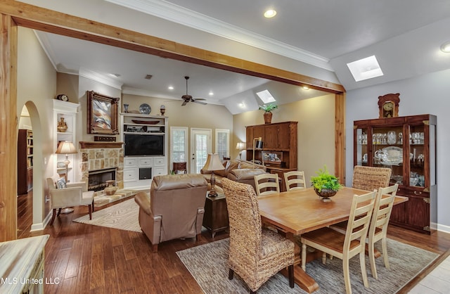 3 Carriage Court Pl, Brandon, MS 39047 - dining area with a skylight, a stone fireplace, a ceiling fan, dark wood-type flooring, and vaulted ceiling