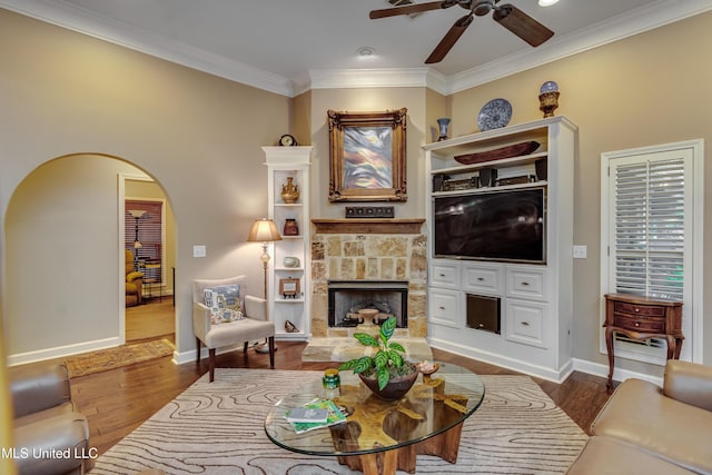 3 Carriage Court Pl, Brandon, MS 39047 - living area featuring ceiling fan, a stone fireplace, crown molding, wood finished floors, and arched walkways
