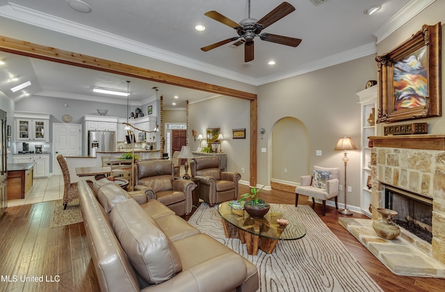 3 Carriage Court Pl, Brandon, MS 39047 - living room with a ceiling fan, a fireplace, arched walkways, light wood-style flooring, and recessed lighting