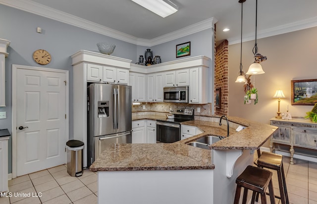 3 Carriage Court Pl, Brandon, MS 39047 - kitchen featuring stainless steel appliances, a sink, light tile patterned flooring, crown molding, and a peninsula