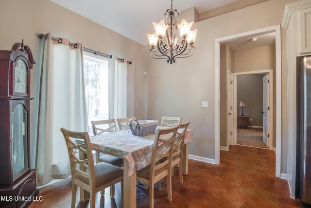 dining space with an inviting chandelier and baseboards