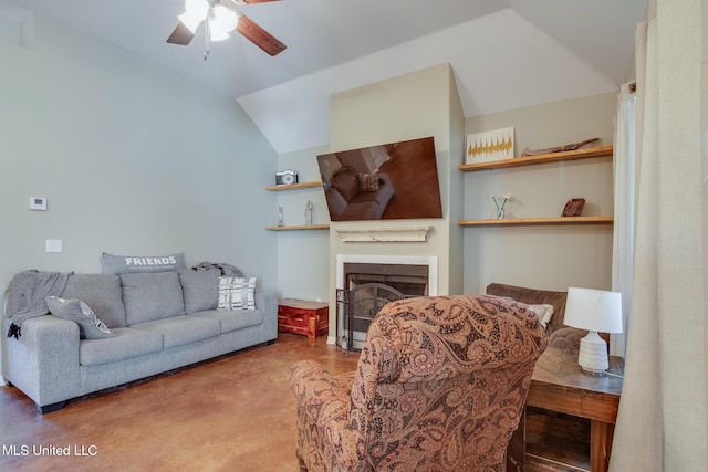living area featuring a fireplace, a ceiling fan, and vaulted ceiling