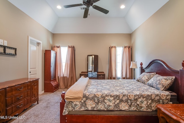 bedroom with light colored carpet, a ceiling fan, vaulted ceiling, and multiple windows