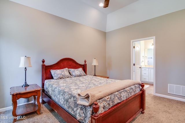 bedroom featuring baseboards, visible vents, ensuite bathroom, and light colored carpet