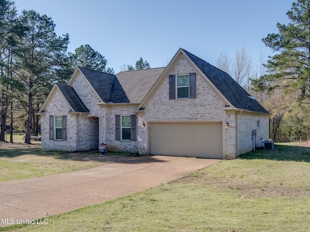 traditional-style house featuring a front lawn, a garage, driveway, central AC, and brick siding