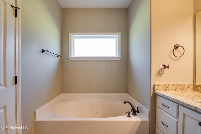 full bath with a whirlpool tub and vanity