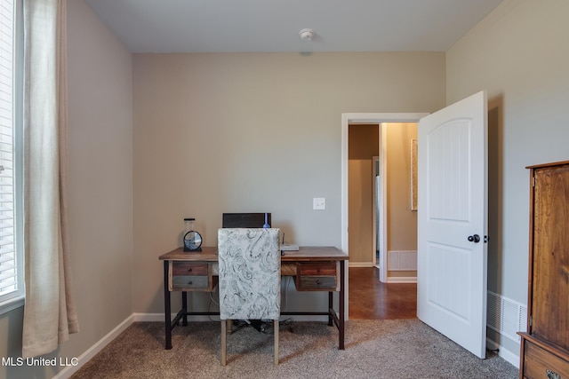 office area featuring baseboards, visible vents, and carpet
