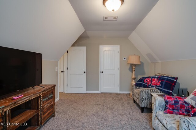 sitting room featuring baseboards, visible vents, carpet flooring, and vaulted ceiling