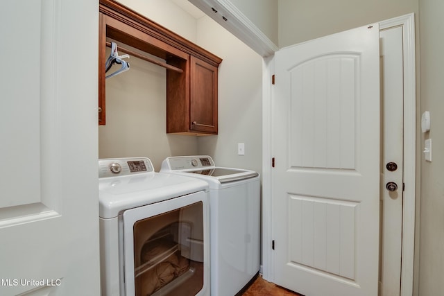 washroom with independent washer and dryer and cabinet space