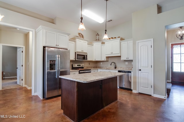 kitchen with concrete floors, visible vents, stainless steel appliances, and a center island
