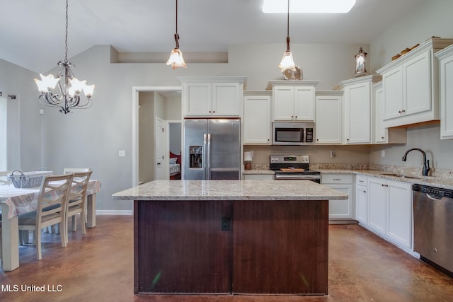kitchen with concrete floors, a sink, appliances with stainless steel finishes, and a kitchen island