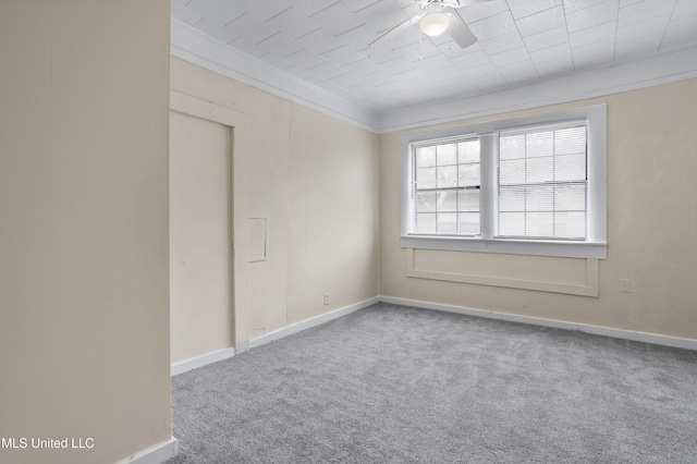 spare room featuring carpet flooring, ceiling fan, and ornamental molding