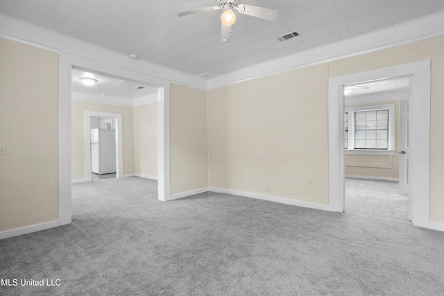 carpeted spare room with crown molding and ceiling fan