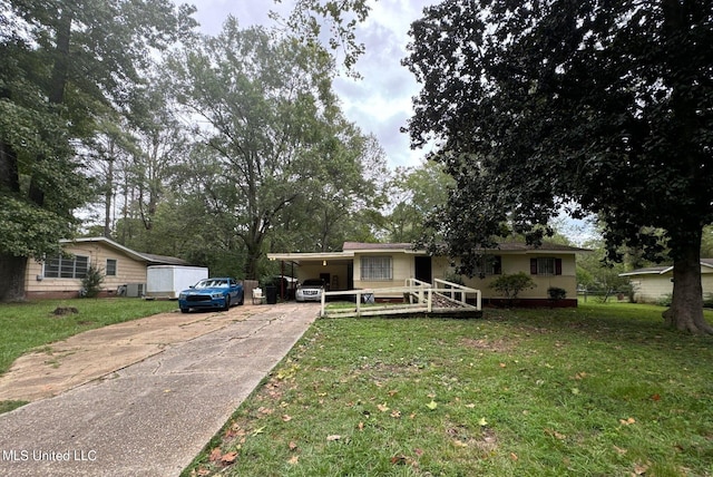 view of front facade with a front yard and a carport