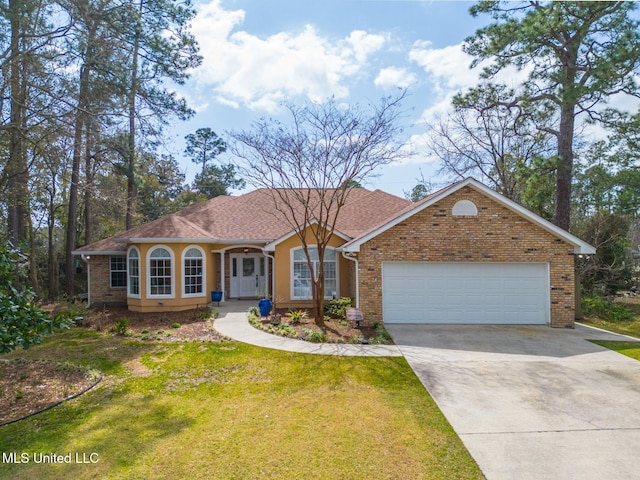 view of front of house featuring brick siding, a front lawn, an attached garage, and driveway