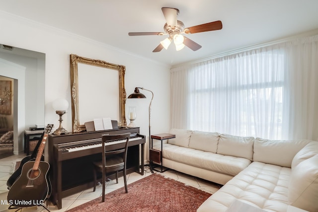 living area with a ceiling fan, crown molding, and tile patterned flooring