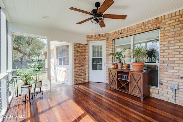 sunroom with a ceiling fan