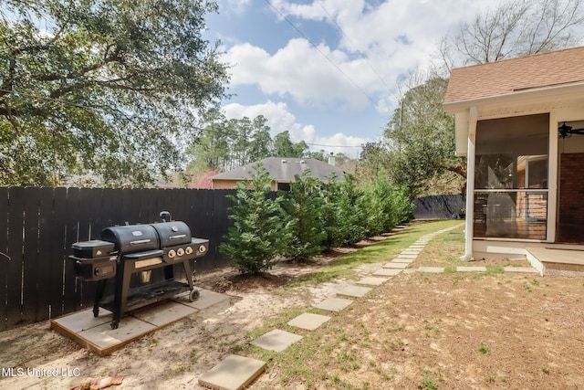 view of yard with fence and a sunroom