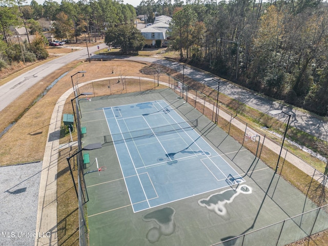 view of tennis court featuring fence