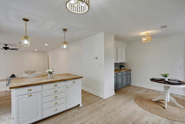 1505 Rosemont Dr, Clinton, MS 39056 - kitchen with wood counters, white cabinetry, baseboards, and light wood-style floors
