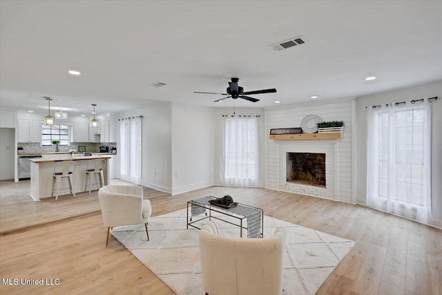 1505 Rosemont Dr, Clinton, MS 39056 - living area featuring a ceiling fan, recessed lighting, light wood-style flooring, baseboards, and a brick fireplace