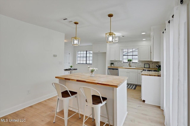 1505 Rosemont Dr, Clinton, MS 39056 - kitchen featuring wooden counters, stainless steel dishwasher, light wood-style flooring, white cabinetry, and recessed lighting