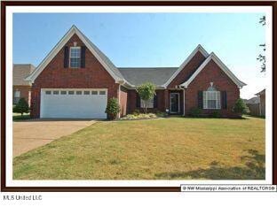 view of front of house with a garage and a front yard