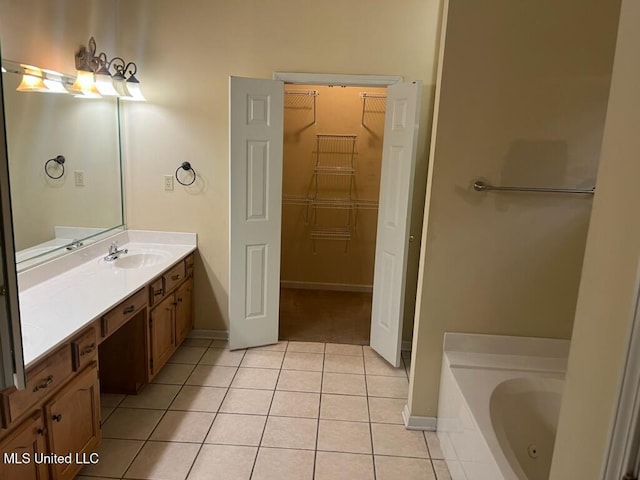 bathroom featuring vanity, tile patterned floors, and a bathtub