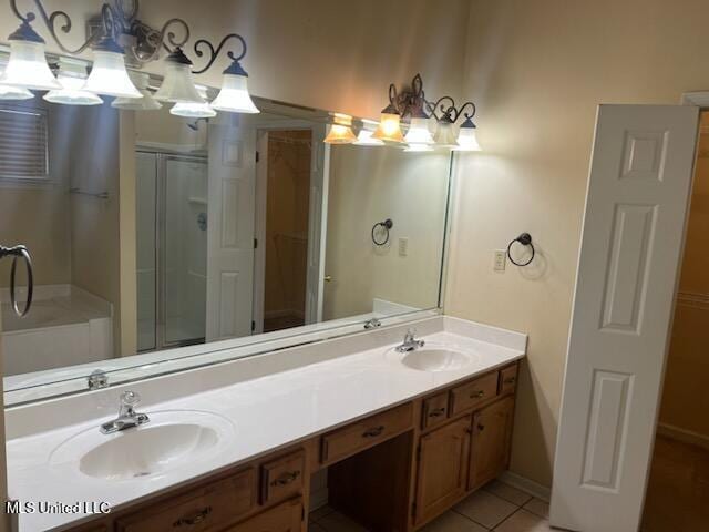 bathroom with tile patterned flooring, vanity, and an enclosed shower