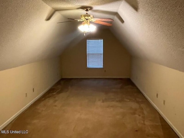 bonus room featuring lofted ceiling, ceiling fan, a textured ceiling, and carpet