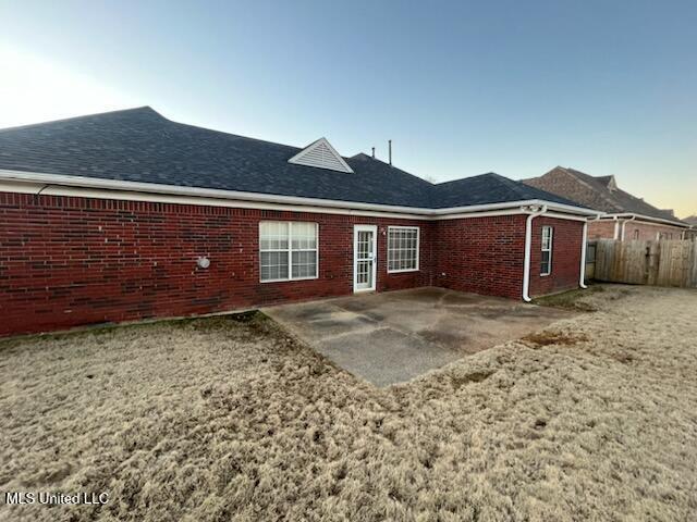 back of house with a yard and a patio area