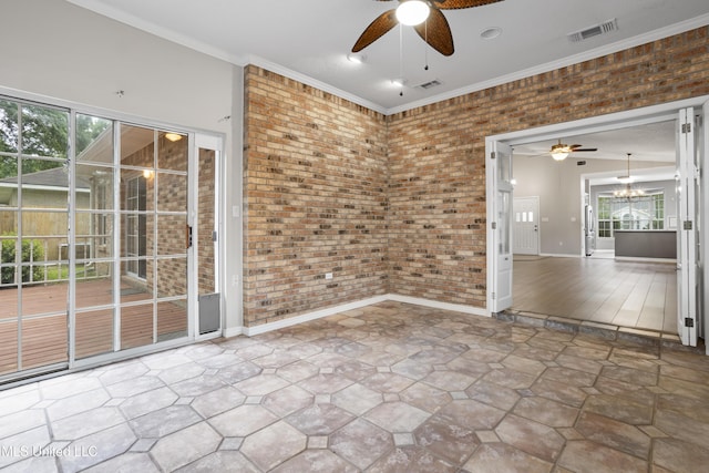 empty room with ceiling fan, brick wall, healthy amount of natural light, a chandelier, and ornamental molding