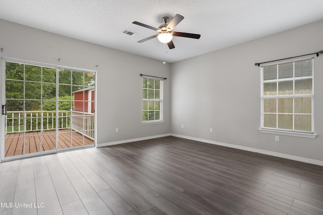 unfurnished room featuring a ceiling fan, wood finished floors, and baseboards