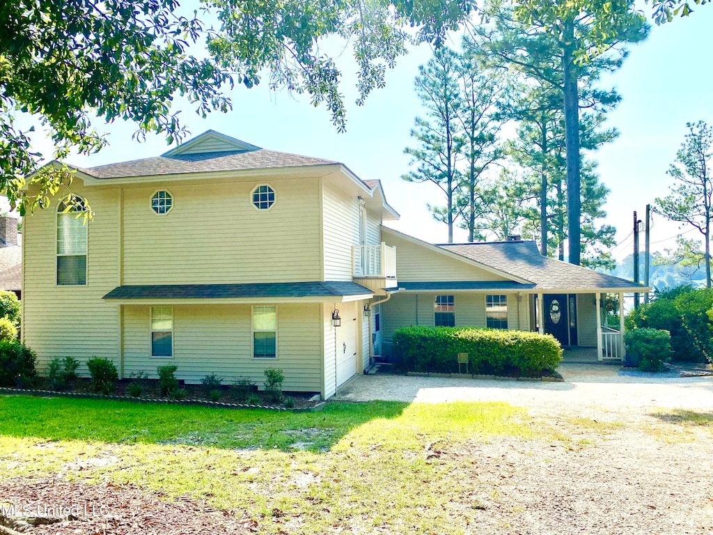 view of front of house featuring a front yard and covered porch