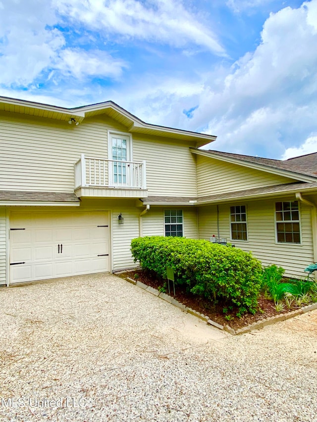 exterior space with a balcony and a garage